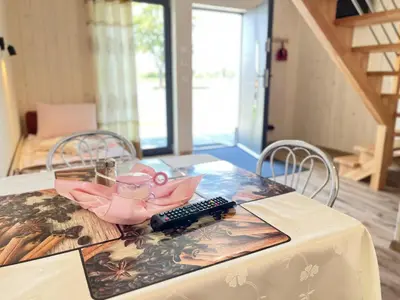 a table with a remote control on top of it at Apartamenty Artur in Oświęcim