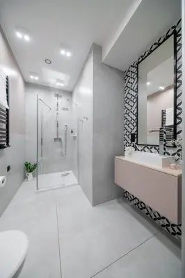 a bathroom with a shower and a sink and a mirror at Platinia Premium Apartments in Kraków