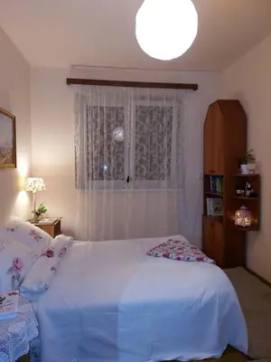 a bedroom with a white bed and a window at Dom w Beskidzie Wyspowym in Słopnice