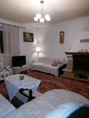 a living room with a couch and a bed and a table at Dom w Beskidzie Wyspowym in Słopnice