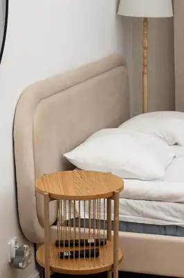 a bedroom with a bed with a table next to it at Comfort Central Studio - by Upstairs in Kraków
