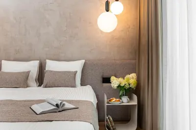 a bedroom with two beds and a table with a book at Boutique Wawel Side in Kraków
