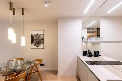a kitchen and dining room with a table and chairs at Boutique Wawel Side in Kraków