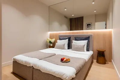 a bedroom with a bed with a bowl of fruit on it at Boutique Wawel Side in Kraków