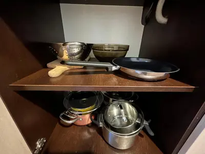 a shelf with pots and pans and bowls on it at Old Town Apartments - free parking Przemysłowa str in Kraków