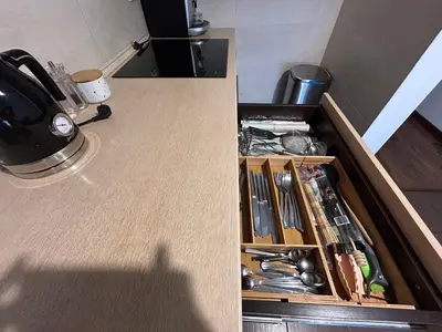 a kitchen counter with a drawer with utensils at Old Town Apartments - free parking Przemysłowa str in Kraków