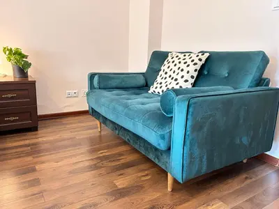 a blue couch sitting in a living room at Old Town Apartments - free parking Przemysłowa str in Kraków