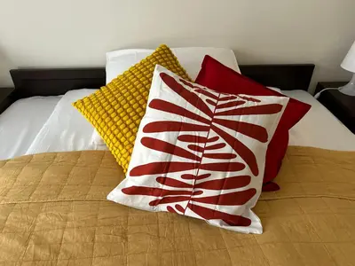 a bed with four pillows on top of it at Old Town Apartments - free parking Przemysłowa str in Kraków