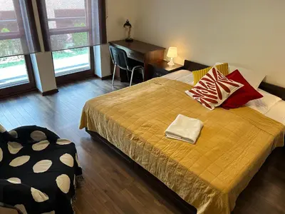 a bedroom with a bed and a desk and a chair at Old Town Apartments - free parking Przemysłowa str in Kraków