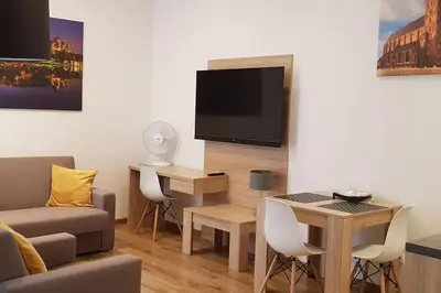 a living room with a couch and a table at Old Town Aptartments - B23 in Kraków