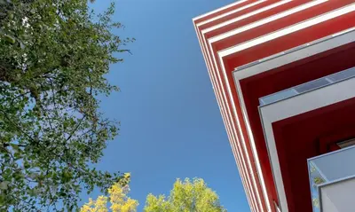 a red building with a blue sky in the background at Apartament Białoprądnicki Siewna in Kraków