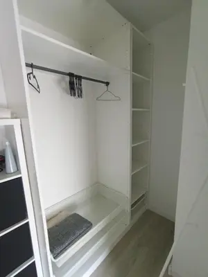 a white walk in closet with a glass door at Apartament Białoprądnicki Siewna in Kraków