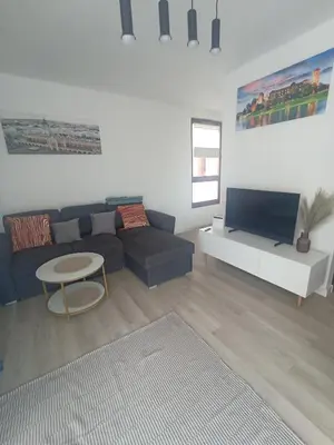 a living room with a couch and a table at Apartament Białoprądnicki Siewna in Kraków