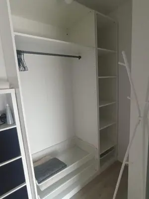 a walk in closet with white walls and shelves at Apartament Białoprądnicki Siewna in Kraków