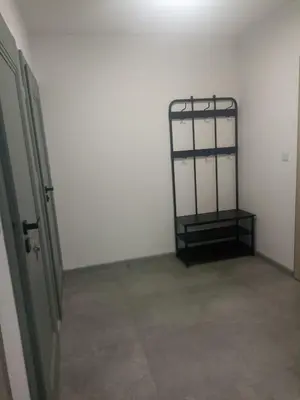 an empty room with a metal bed in the corner at Apartament Białoprądnicki Siewna in Kraków