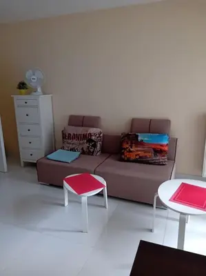 a living room with a couch and two tables at Apartament Grzegórzecka centrum in Kraków