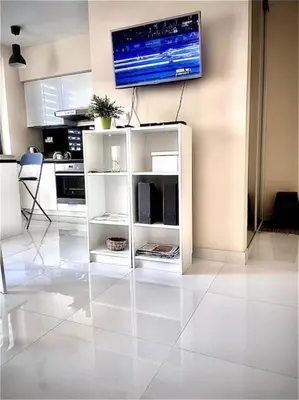 a living room with a tv on a wall at Apartament Grzegórzecka centrum in Kraków