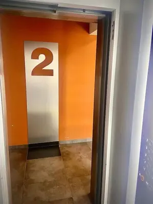 a hallway with a door with the number on it at Apartament Grzegórzecka centrum in Kraków