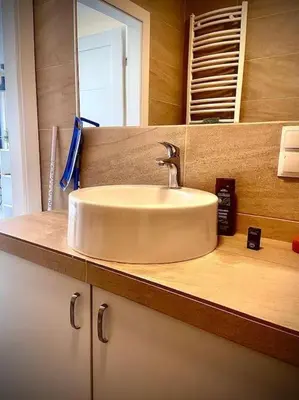 a bathroom counter with a sink and a mirror at Apartament Grzegórzecka centrum in Kraków