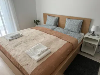 a bedroom with a large bed with two pillows on it at Luksusowy Apartament in Jaworzno