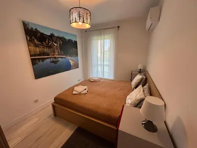 a bedroom with a bed and a painting on the wall at Luksusowy Apartament in Jaworzno
