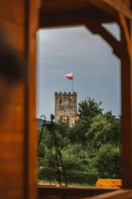 a castle with a flag on top of it at Chata Zawrot in Wytrzyszczka