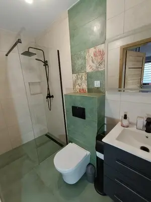 a bathroom with a shower and a toilet and a sink at Noclegi u Edyty in Zator