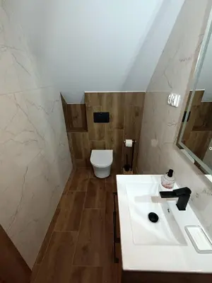 a bathroom with a white sink and a toilet at Noclegi u Edyty in Zator
