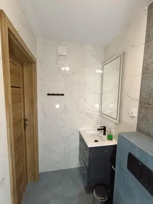 a bathroom with a sink and a shower at Noclegi u Edyty in Zator