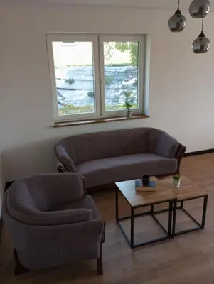 a living room with a couch and a chair and a table at Cracow house under walnut tree in Kraków