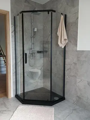 a shower with a glass door in a bathroom at Cracow house under walnut tree in Kraków