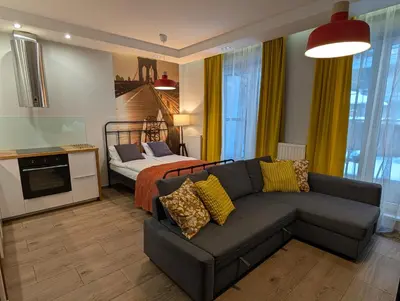 a living room with a couch and a bed at Riverside Studio in Kraków