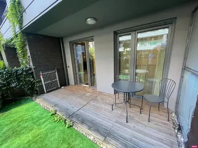 a wooden deck with a table and chairs on it at Riverside Studio in Kraków