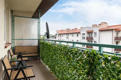 a balcony with benches and a view of buildings at Cozy Apartment with Parking in Kraków by Noclegi Renters in Kraków