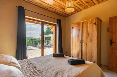 a bedroom with a large bed and a large window at Dom 