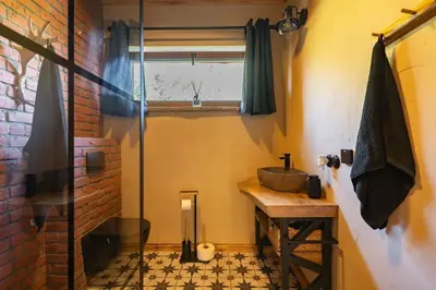 a bathroom with a sink and a glass shower at Dom 