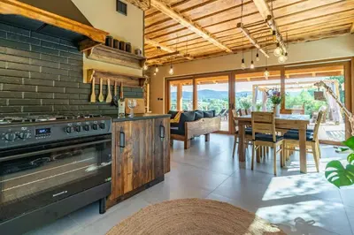 a kitchen with a stove and a dining room at Dom 