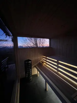 a wooden bench in a room with a window at Dom 