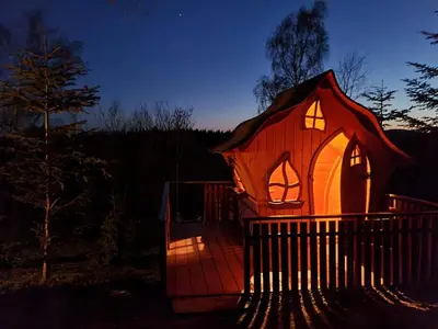 a gingerbread house with its lights on at Domki Pod Biegunem, Wioska Smerfów oraz Wzgórze Gargamela in Żywiec
