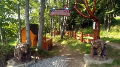 a park with two statues of elephants and a swing at Domki Pod Biegunem, Wioska Smerfów oraz Wzgórze Gargamela in Żywiec