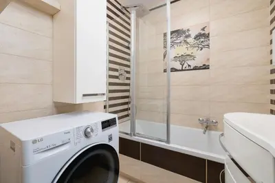 a washing machine in a bathroom with a sink at Przytulny Apartament z 3 sypialniami z Biurkiem do Pracy Zdalnej by Noclegi Renters in Kraków