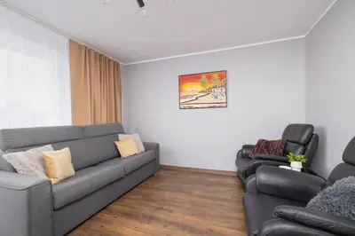 a living room with a couch and two chairs at Przytulny Apartament z 3 sypialniami z Biurkiem do Pracy Zdalnej by Noclegi Renters in Kraków