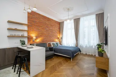 a living room with a couch and a bed at Studio apartment - Starowiślna 41 street in Kraków