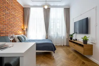 a hotel room with a bed and a tv at Studio apartment - Starowiślna 41 street in Kraków