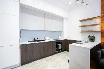 a kitchen with white cabinets and a sink at Studio apartment - Starowiślna 41 street in Kraków