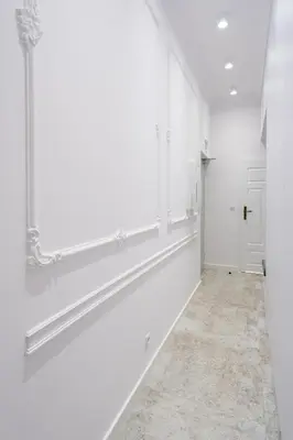 a white hallway with white walls and a mirror at Studio apartment - Starowiślna 41 street in Kraków