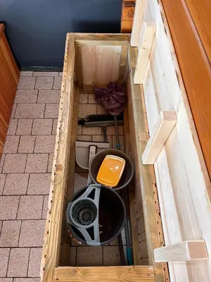 an open wooden box with a toilet and a chair at Domki- Limanowa domek 3 domek z jacuzzi i sauną in Limanowa