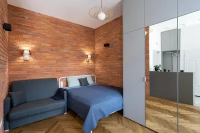 a room with a bed and a brick wall at Apartment with balcony - Starowiślna 41 in Kraków