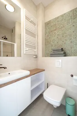a bathroom with a white toilet and a sink at Apartment with balcony - Starowiślna 41 in Kraków