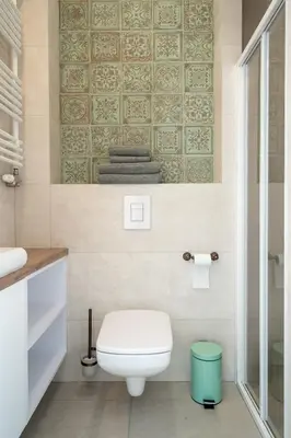 a bathroom with a white toilet and a shower at Apartment with balcony - Starowiślna 41 in Kraków